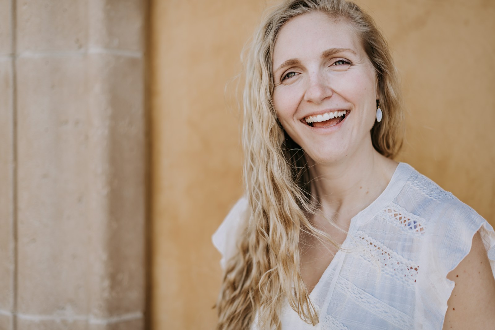 Photo by Tim Mossholder smiling woman in white lace shirt